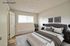 Virtually staged bedroom showcasing layout possibilities with a large bed at CAMPBELL PARK.
