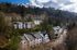 Aerial drone view of multi-level buildings on a hillside at Berkeley Heights Apartment Homes.