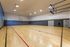 Full-size indoor basketball court facility with polished wood floors at Berkeley Heights Apartment Homes.
