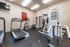 Clean exercise room displaying weight training machines at Berkeley Heights Apartment Homes.