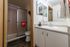 Tidy bathroom layout featuring a bright vanity mirror at Berkeley Heights Apartment Homes.