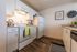 Well-lit galley kitchen with complete appliances at Berkeley Heights Apartment Homes.