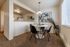 Intimate dining table set up right next to an open kitchen bar at Berkeley Heights Apartment Homes.