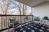 Private covered apartment balcony with outdoor furniture at Berkeley Heights Apartment Homes.