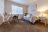 Bright bedroom layout featuring a small desk setup at Berkeley Heights Apartment Homes.