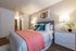 Modern bedroom styling showcasing a colorful accent blanket at Berkeley Heights Apartment Homes.