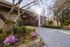 Landscaped entry path with flowers leading to the leasing office at Creekwood Apartments.