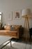 brown sofa and large tripod lamp