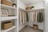 Virtually Staged Walk-in closet at Orchard mesa with shelves and room to hang clothes