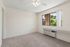 Living Room in a unit at Orchard Mesa with wood floors and white walls