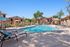Pool at Orchard Mesa with pool chairs and umbrellas
