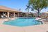 Pool at Orchard Mesa with pool chairs and umbrellas