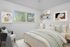 virtually staged bedroom with bed, window, chair, and artwork.