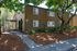 Shady Glen Exterior with trees, brown paint and blue shutters