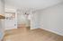 Living Room at Timber Flats Unit E101 with view into entryway and wood floors