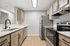 Kitchen at Timber Flats with wood cabinets, black hardware and wood floors