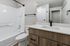 Bathroom at Timber Flats unit E101, wood cabinets and black hardware