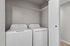 Laundry in Timber Flats unit E101, white washer and dryer