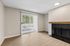 Living Room at Timber Flats with fireplace with black tile and a wood mantle
