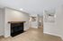 Living Room with black tile and wood mantle