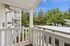 Patio of unit J201 with ciew above carport and trees