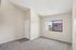 living room at ventura villas 1x1 with carpet and a window and entry door