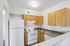 kitchen in 2xa floorplan at ventura villas with wood cabinets and white appliances
