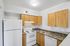 kitchen in 2xa floorplan at ventura villas with wood cabinets and white appliances
