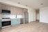 Studio at Cedarline with wood floors, wood and green cabinets and stainless steel appliances