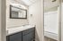 Deer Valley Village bathroom with grey vanity and view into the white shower and tub area.