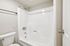 White shower and tub combo with chrome fixtures in a Deer Valley Village apartment home.