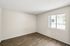 Spacious Deer Valley Village bedroom featuring vinyl plank flooring and a large window.