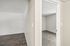 Hallway view at Deer Valley Village showing wood-style vinyl flooring and neutral interior paint.