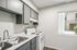 Kitchen workspace in Deer Valley Village featuring a double stainless steel sink and grey cabinetry.
