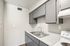 View of grey kitchen cabinets and stainless steel sink in a Deer Valley Village apartment home.