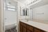 Bathroom at Silver Creek with wood cabinets and a sink and a separate room with a toilet and tub/shower