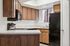 Kitchen at Silver Creek with black appliances and wood cabinets