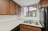 Kitchen at Silver Creek with black appliances and wood cabinets