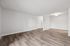 Living room of a unit at Peoria Grand with wood floors and a dining nook