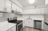 Kitchen at Peoria Grand with stainless steel appliances and all white cabinets