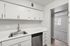 Kitchen at Peoria Grand with stainless steel appliances and all white cabinets