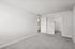 Bedroom at Peoria grand with closet and window, light grey carpet and light grey walls