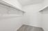 Walk-in closet at peoria grand with carpet and shelving and hanging rods