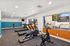 gym at peoria grand with view out to the pool