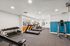 Gym at peoria grand with free weights, equipment and view out to the pool