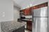 Kitchen at Solaris at the biltmore with stainless appliances and dark wood cabinets