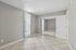 bedroom at solaris at the biltmore with tile flooring and mirrored closet doors and a tall window