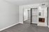 bedroom at Solaris at the biltmore with carpet and grey paint and a closet with mirrored doors and an attached bathroom