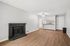 Living room at creekwood with a fireplace with black tile around it and hardwood floors