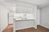 Kitchen with space for barstools and al white appliances